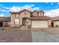 Two-story house with a beige exterior, two-car garage, and landscaping at 524 N Leoma Ln, Chandler, AZ 85225