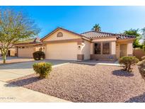 One-story house with a two-car garage and well-maintained landscaping at 7981 W Caron Dr, Peoria, AZ 85345