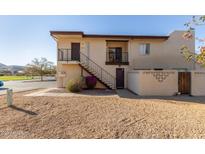 Tan two-story building with stairs and a small balcony at 812 E Joan De Arc Ave, Phoenix, AZ 85022