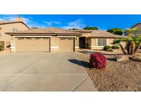 House exterior features two-car garage and desert landscaping at 8630 W Melinda Ln, Peoria, AZ 85382