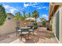 Relaxing brick patio with seating area, umbrella, and fountain at 9279 E Camino Del Santo --, Scottsdale, AZ 85260