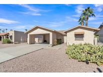 House exterior featuring a carport and desert landscaping at 9444 E Minnesota Ave, Sun Lakes, AZ 85248