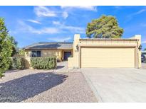 Ranch-style home with a two-car garage and desert landscaping at 9530 E Sherwood Way, Sun Lakes, AZ 85248