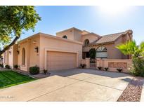 Stunning two-story home with a large driveway and mature landscaping at 10069 E Turquoise Ave, Scottsdale, AZ 85258