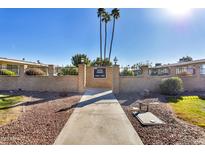 Front view of a light beige building with a walkway and landscaping at 13635 N 111Th Ave, Sun City, AZ 85351