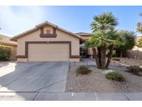 Single-story home with a two-car garage and desert landscaping at 14215 W Mountain Laurel Trl, Surprise, AZ 85374