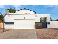 White two-story house with a two-car garage and basketball hoop at 1506 E Topeka Dr, Phoenix, AZ 85024