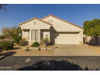 Single-story home with a two-car garage and desert landscaping at 15513 W Coral Pointe Dr, Surprise, AZ 85374