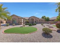 Single-story home with landscaped yard and a three-car garage at 18009 W Denton Ave, Litchfield Park, AZ 85340