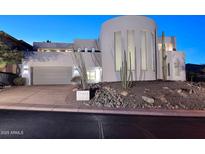 Stunning contemporary home with a curved facade and desert landscaping at 18258 N 15Th Pl, Phoenix, AZ 85022