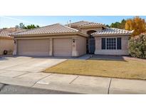 Two-story house with a three-car garage and landscaped yard at 21918 N 66Th Ln, Glendale, AZ 85310