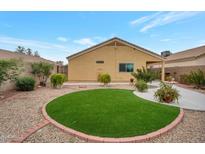 Artificial turf backyard with a circular design and pathway at 23677 N Desert Dr, Florence, AZ 85132