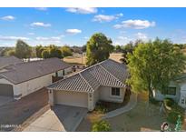 Aerial view of single-story house with tile roof, driveway, and landscaped yard at 2726 S Keene --, Mesa, AZ 85209