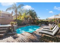 Inviting pool and spa with water feature and plenty of lounge space at 2769 E Cedar Pl, Chandler, AZ 85249