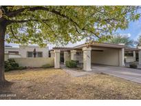 Single-level home with carport and landscaped front yard at 2911 W Lamar Rd, Phoenix, AZ 85017