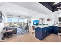 Open living area with city views, hardwood floors, and stylish furnishings at 4750 N Central Ave # N16, Phoenix, AZ 85012