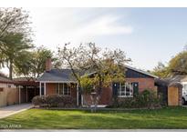 Brick home with a charming front yard and mature tree at 533 W Lewis Ave, Phoenix, AZ 85003