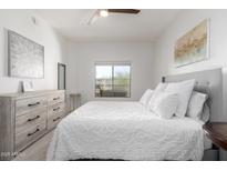 Bright bedroom with a white comforter and dresser at 5350 E Deer Valley Dr # 2403, Phoenix, AZ 85054