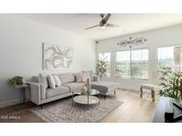 Bright living room with sectional sofa, coffee table, and large windows at 5350 E Deer Valley Dr # 2403, Phoenix, AZ 85054