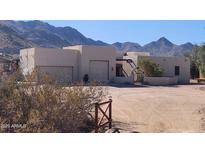 Inviting desert home with two-car garage, arched gated entrance, and mountain views at 5713 W Sun Dance Dr, Queen Creek, AZ 85144
