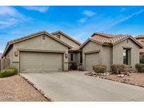 Two-car garage and front yard with drought-tolerant landscaping at 7606 E Globemallow Ln, Gold Canyon, AZ 85118