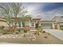 Charming single-story home showcasing desert landscaping, a two-car garage, and a brick facade, creating inviting curb appeal at 1536 W Blaylock Dr, Phoenix, AZ 85085