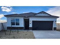 One-story house with a two-car garage and desert landscaping at 1587 S 239Th Dr, Buckeye, AZ 85326