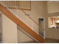 Indoor view of a wooden staircase with a white railing at 2138 W Beaubien Dr, Phoenix, AZ 85027