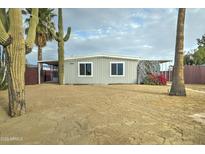 Single-wide manufactured home with desert landscaping and a gray exterior at 2191 S Descanso Rd, Apache Junction, AZ 85119