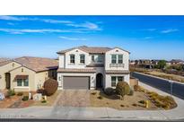 Two-story house with gray garage door and landscaping at 22413 N 101St Ave, Peoria, AZ 85383