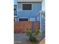 Blue house exterior with gated entry and landscaping at 2301 E University Dr # 131, Mesa, AZ 85213