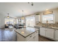 Modern kitchen with granite countertops and white cabinetry at 2414 W Gambit Trl, Phoenix, AZ 85085