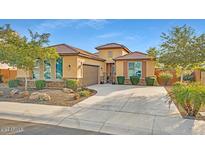 Beautiful one-story home with a three-car garage and well-manicured landscaping at 26119 W Wahalla Ln, Buckeye, AZ 85396