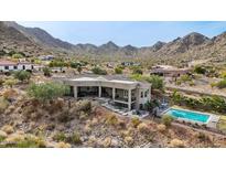 Aerial view of house, showcasing the backyard, pool, and mountain views at 34157 N Mirage Ct, San Tan Valley, AZ 85144