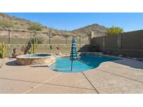 Inviting kidney-shaped pool with spa and mountain views at 38213 N Raleigh Way, Anthem, AZ 85086