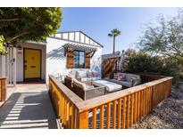 Bright front porch with yellow door and wooden fence at 45 E Woodward Dr, Phoenix, AZ 85004