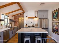 Modern kitchen with stainless steel appliances and marble countertops at 45 E Woodward Dr, Phoenix, AZ 85004