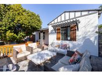 Inviting patio with wicker furniture and a coffee table at 45 E Woodward Dr, Phoenix, AZ 85004