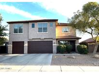 Two-story house with a two-car garage and landscaped front yard at 45717 W Ranch Rd, Maricopa, AZ 85139