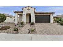 Single-story home with a dark brown garage door and landscaped front yard at 5715 S Winchester --, Mesa, AZ 85212