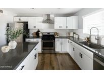 Modern kitchen with white cabinets, stainless steel appliances, and a large island at 7301 E Almeria Rd, Scottsdale, AZ 85257