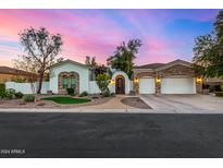 Stunning two-story home with stone accents and a three-car garage at 8951 E Wethersfield Rd, Scottsdale, AZ 85260