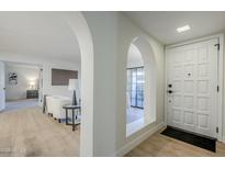 Bright entryway with arched hallways and white door at 10410 N Cave Creek Rd # 1220, Phoenix, AZ 85020