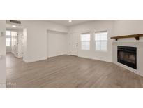 Bright living room with fireplace and wood-look floors at 1245 W 1St St # 103, Tempe, AZ 85281