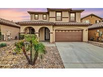 Two-story house with tan exterior, arched entryway, and two-car garage at 1715 W Satinwood Dr, Phoenix, AZ 85045