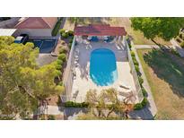 Inviting community pool with surrounding patio furniture and landscaping at 17243 N 16Th St # 1, Phoenix, AZ 85022