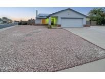 House exterior featuring a two-car garage and landscaping at 19002 N 47Th Dr, Glendale, AZ 85308