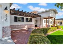 Inviting front porch with brick flooring and pergola at 2130 E San Juan Ave, Phoenix, AZ 85016