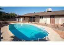 Inviting kidney-shaped pool with ample deck space at 2215 E Des Moines Cir, Mesa, AZ 85213