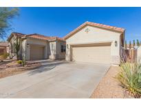 Two-car garage, desert landscaping, and neutral-colored exterior at 2410 W Aloe Vera Dr, Phoenix, AZ 85085